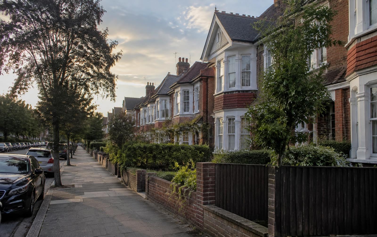 Edwardian houses with slate and clay tile roofs along a residential street